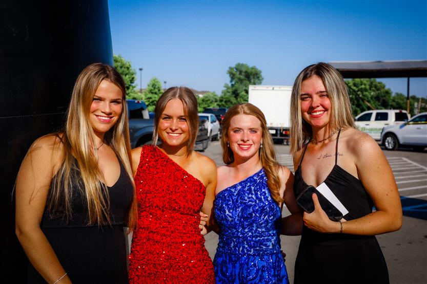 A group of four young women stand together